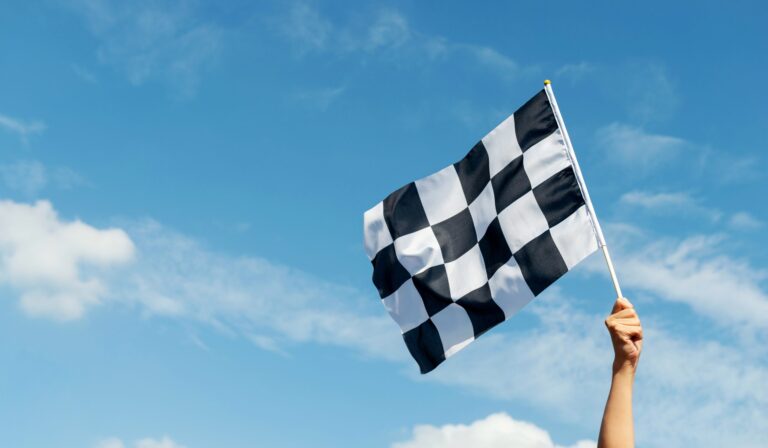 The chequered flag waves at the start of a Formula 1 race
