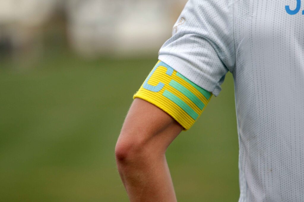 A football player wearing a captain's armband