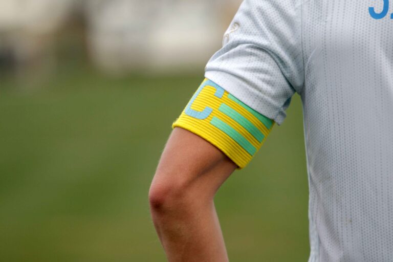 A football player wearing a captain's armband